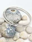 Double silver bangle with joining star.