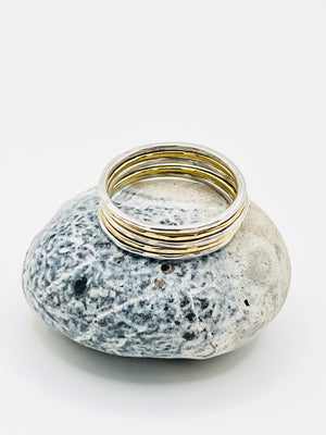 Silver and gold stacking rings.