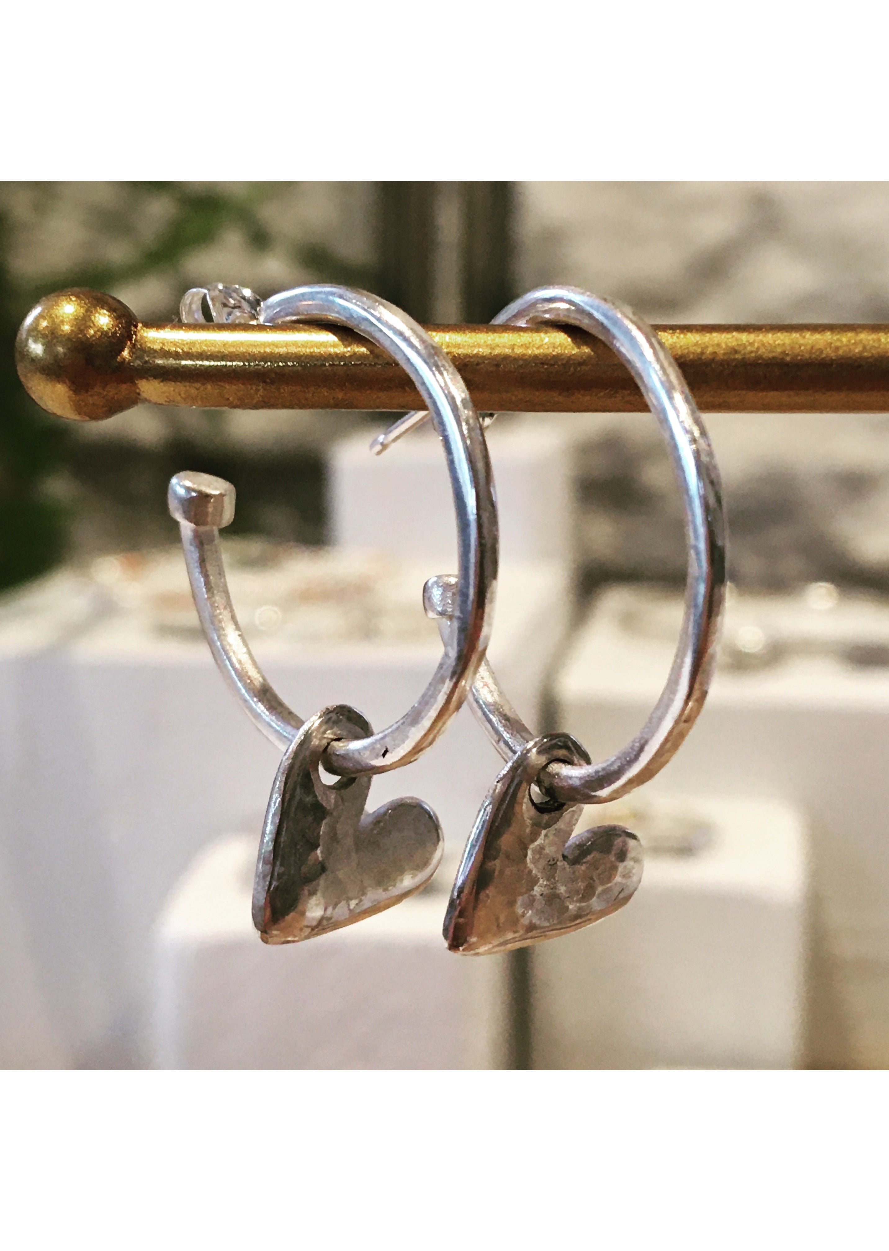 Silver hoops with hanging hearts.