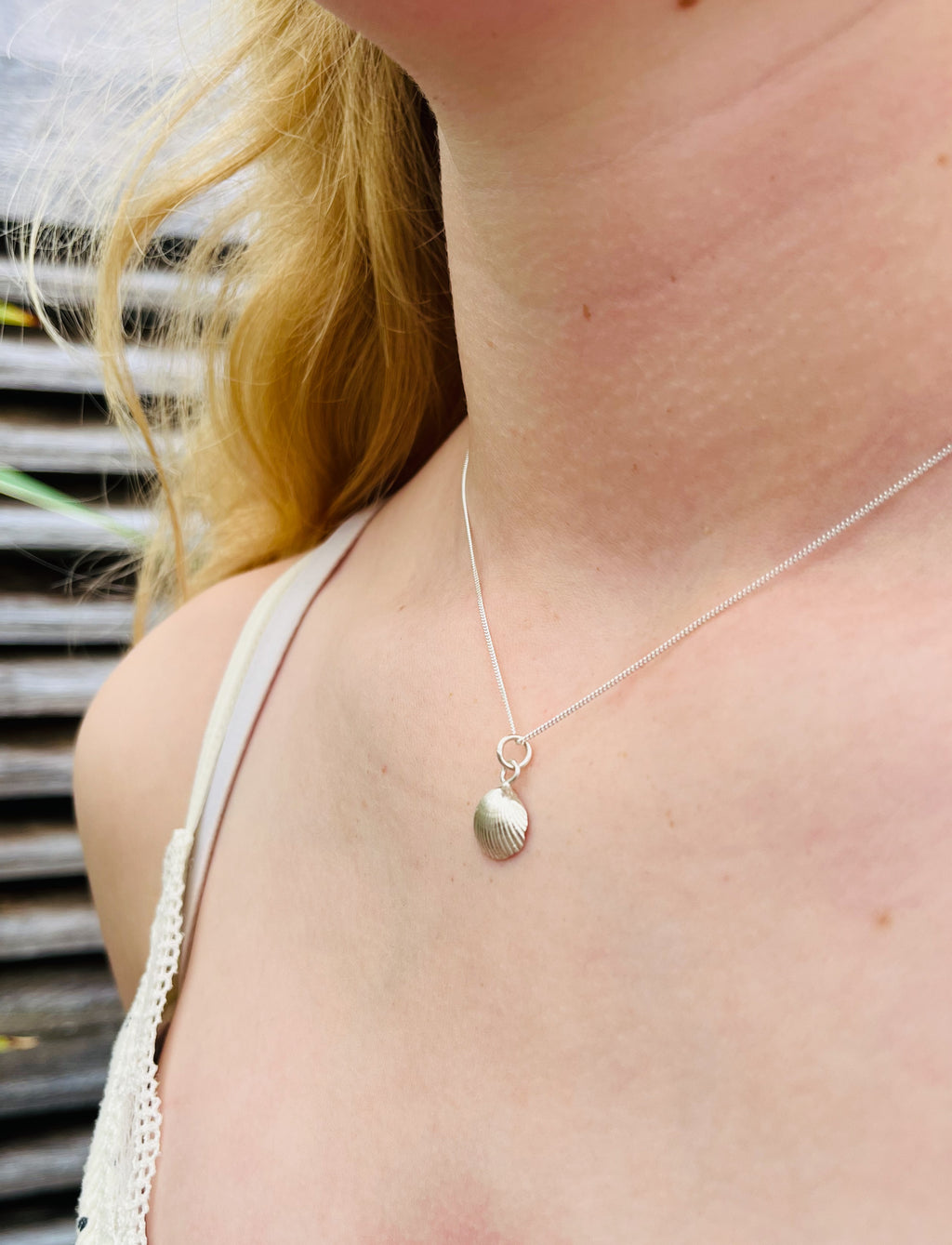 Silver scallop necklace.