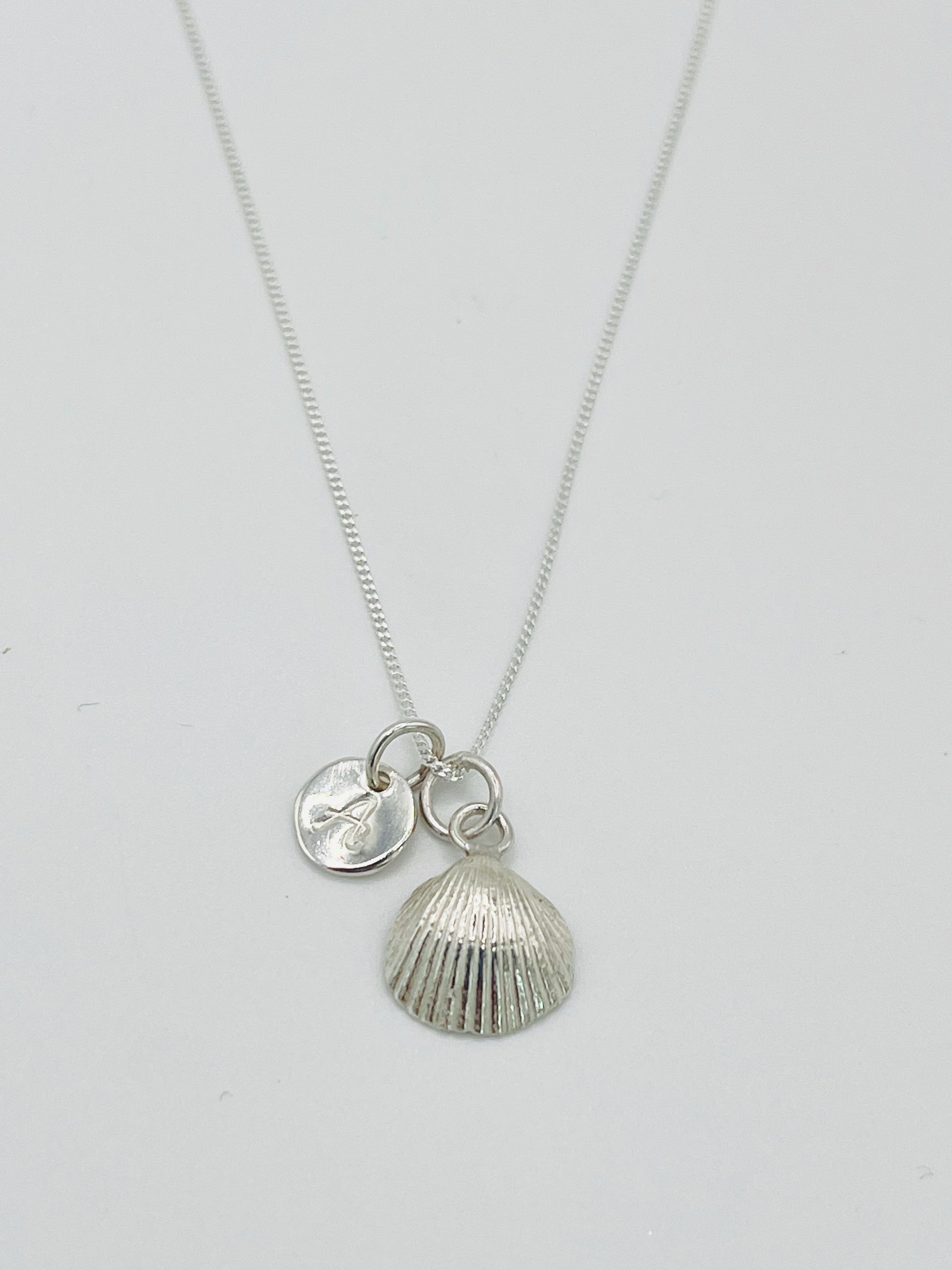 Silver personalised scallop shell necklace.