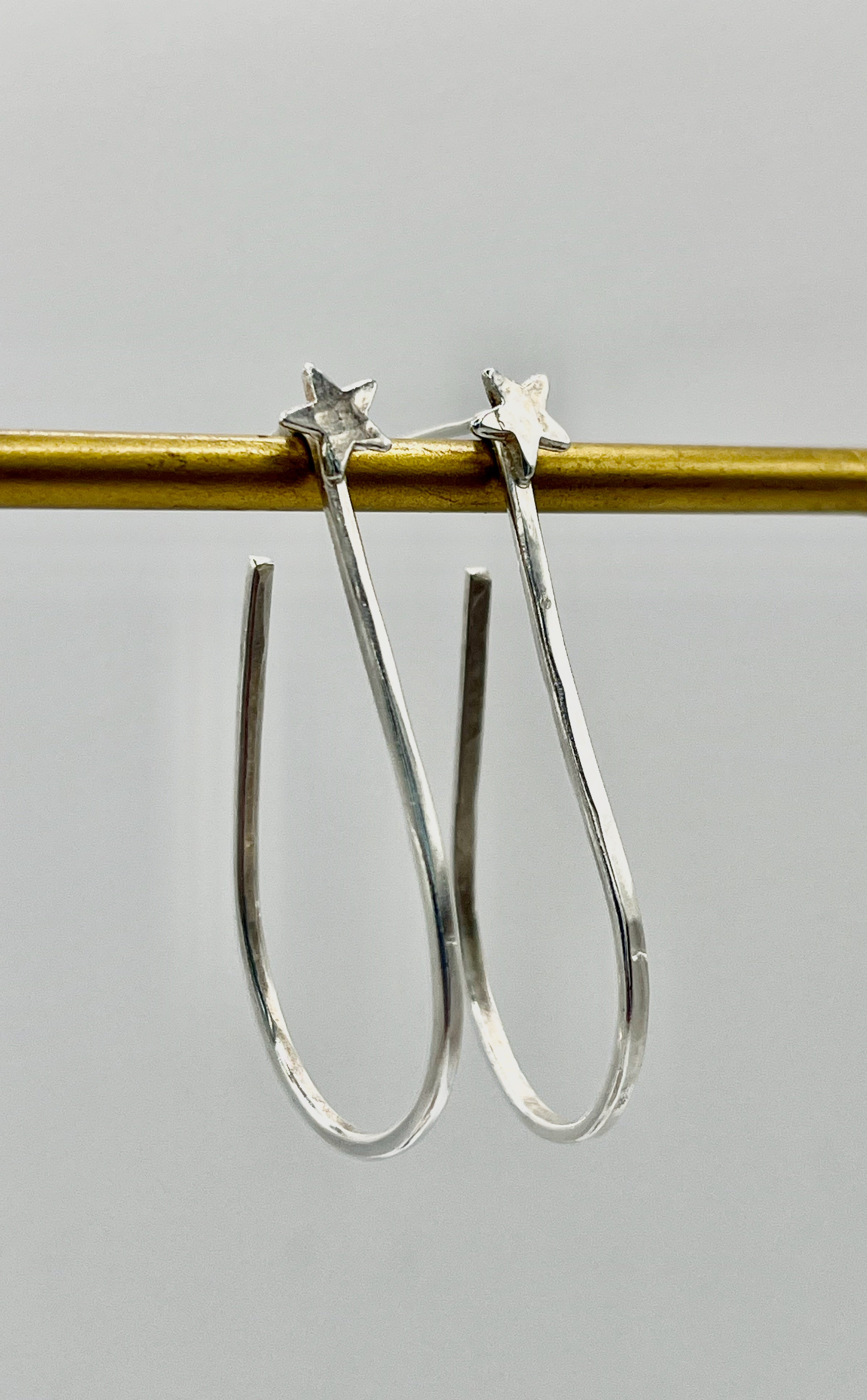 Silver star hoops.