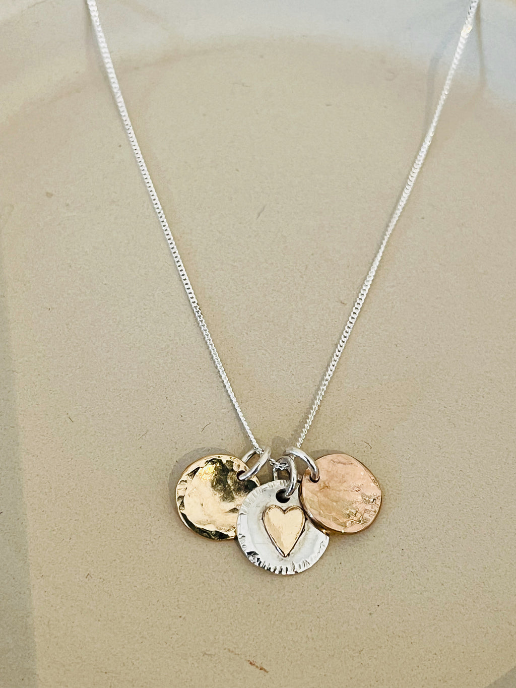 Trio disc necklace with gold heart.