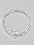 Triple stacking bangle with joining heart.