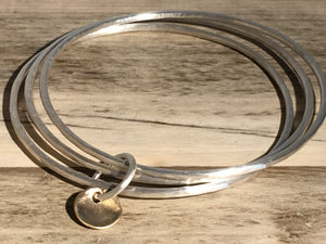 Brushed silver triple bangle.